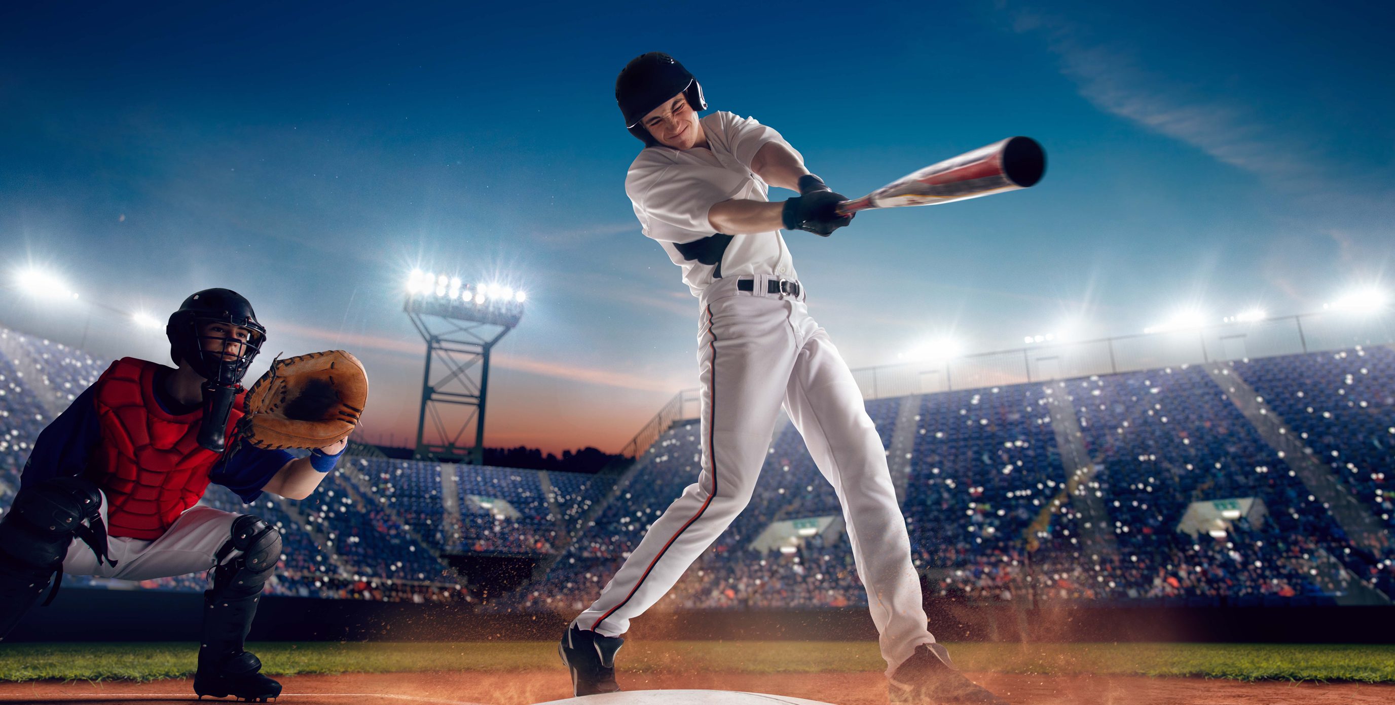 In a brightly lit stadium at night, a baseball player swings his bat hard as he hopes for a homerun.