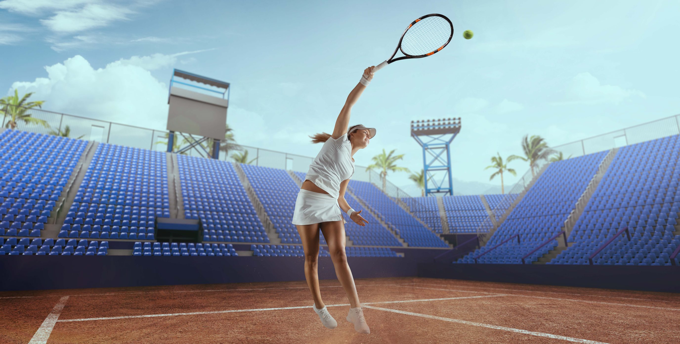 A female tennis player practicing a high forehand shot in a tennis stadium at daytime.