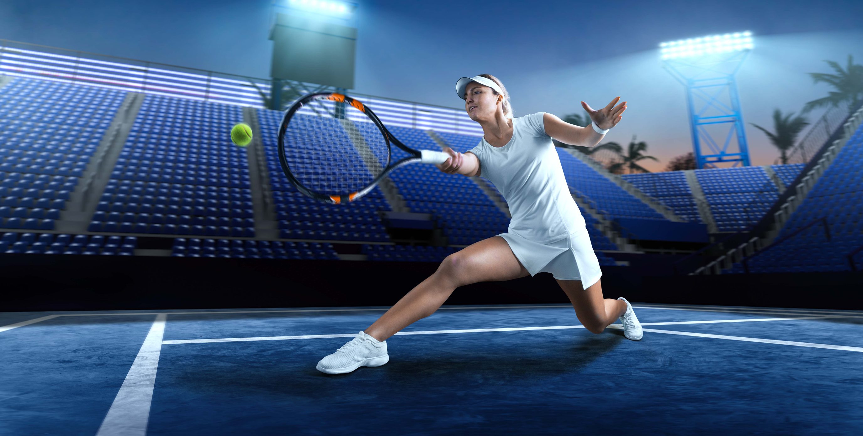 A female tennis player practicing a forehand shot in a tennis stadium at night.